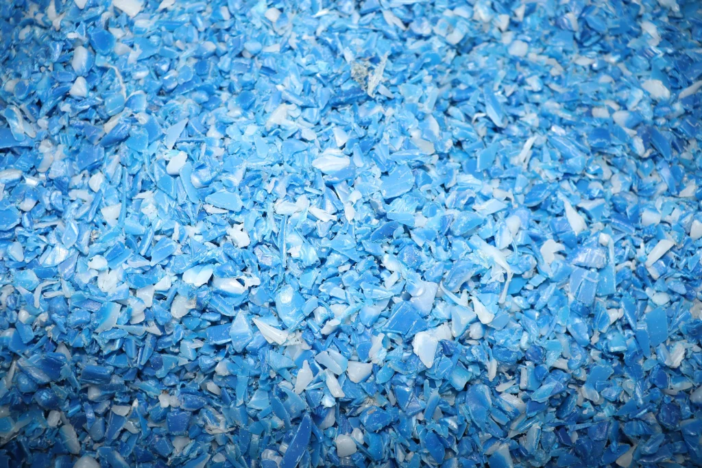 Blue HDPE flakes after crushing
