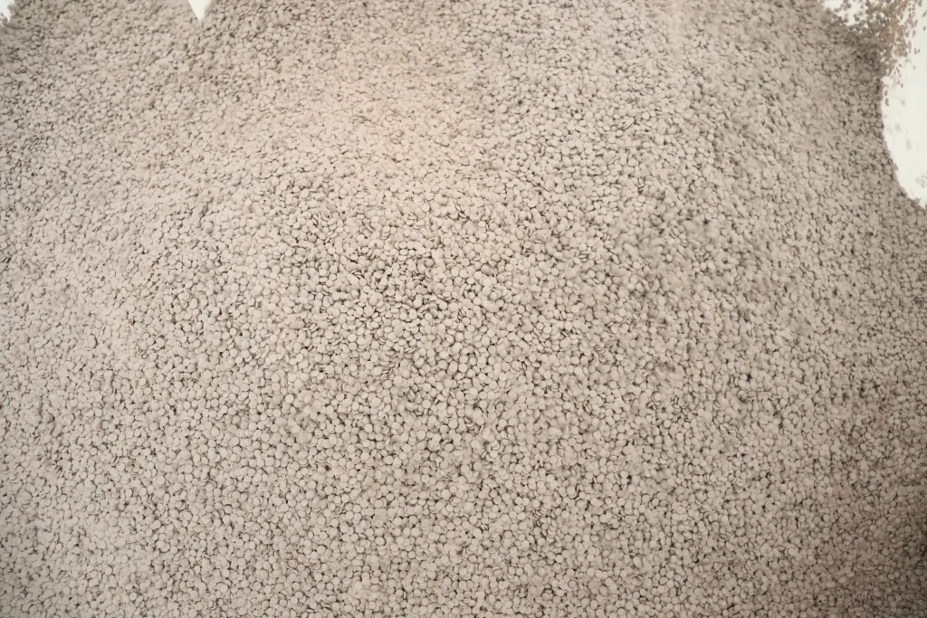 Grey recycled pellets after pelletizing mixed flakes