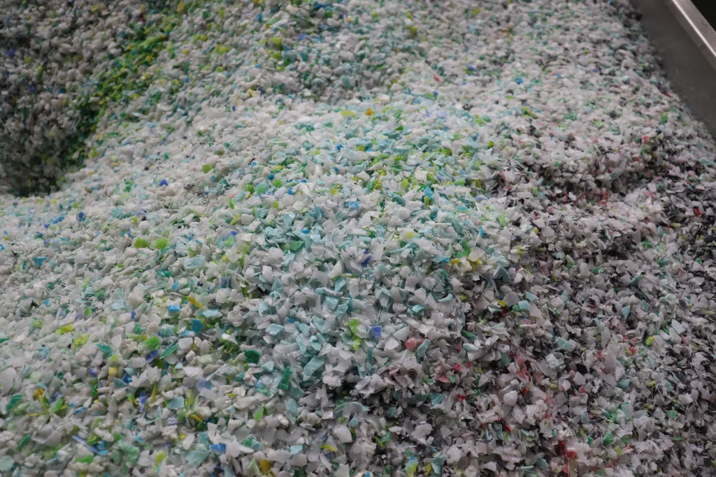 Light grey plastic flakes before pelletizing
