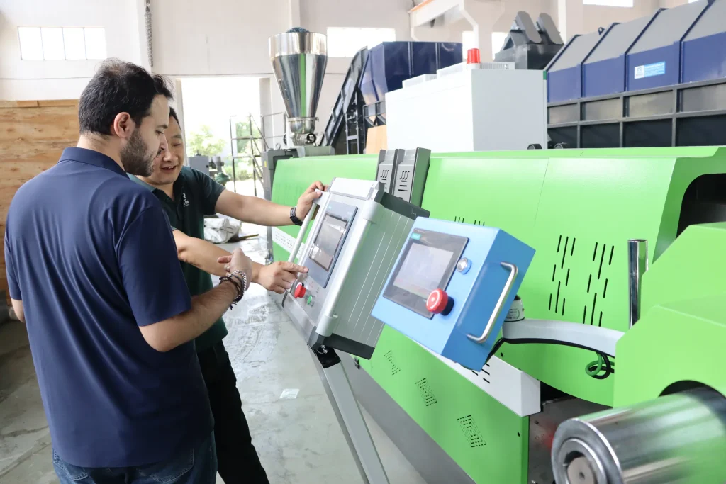 Operator setting the HDPE PP flake pelletizing line control panel